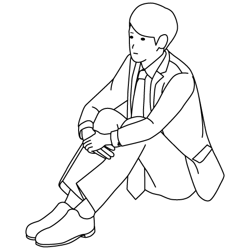 体育座りのスーツを着た男性